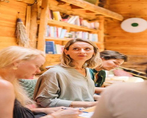 A community cultural workshop gathering where individuals participate in an open dialogue around books